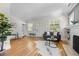 Bright living room with hardwood floors, a decorative fireplace, and comfortable seating at 864 Garfield St, Denver, CO 80206