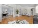 Spacious living room with hardwood floors, comfortable seating, and a glimpse into the dining area at 864 Garfield St, Denver, CO 80206