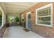 Inviting covered porch with a porch swing, brick accents, and a welcoming entrance at 864 Garfield St, Denver, CO 80206