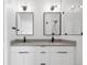 Modern bathroom featuring double vanity with black faucets, sconces and framed mirrors, plus a glass shower door at 4232 Jason St # 2, Denver, CO 80211
