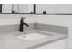 The sink has a black faucet, a light gray counter, and white cabinets below at 4232 Jason St # 2, Denver, CO 80211