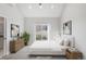 Staged bedroom featuring a large window, modern furnishings, and stylish decor at 4232 Jason St # 2, Denver, CO 80211