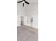 Bright bedroom featuring high ceilings, a ceiling fan, light gray walls, carpet flooring, and easy access to the bathroom at 4232 Jason St # 2, Denver, CO 80211