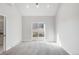 Bright bedroom with a sliding glass door leading to a balcony and a glimpse of city buildings at 4232 Jason St # 2, Denver, CO 80211