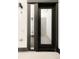 A modern black front door with a glass panel and sidelight, set against a light grey exterior wall at 4232 Jason St # 2, Denver, CO 80211