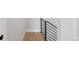 Clean hallway with light wood floors and modern black railing at 4232 Jason St # 2, Denver, CO 80211