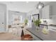 Bright, staged living room featuring wood floors, modern decor, and natural light from a large window at 4232 Jason St # 2, Denver, CO 80211