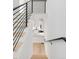Modern staircase with black metal railing leading to the kitchen and living area at 4232 Jason St # 2, Denver, CO 80211