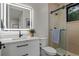 Modern bathroom featuring a sleek vanity with an illuminated mirror and a glass-enclosed shower at 2580 Saddleback Dr, Castle Rock, CO 80104