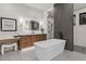 Sleek bathroom features a modern tub, walk-in shower, vanity with a lighted mirror, and stylish floors at 2580 Saddleback Dr, Castle Rock, CO 80104