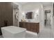 Modern bathroom featuring a freestanding tub, walk-in shower, and a vanity with illuminated mirror at 2580 Saddleback Dr, Castle Rock, CO 80104