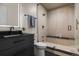 Modern bathroom featuring a walk-in shower with a bench, a black vanity and black accents at 2580 Saddleback Dr, Castle Rock, CO 80104