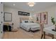 Elegant bedroom with hardwood floors, neutral tones, modern art, and a comfortable seating area at 2580 Saddleback Dr, Castle Rock, CO 80104