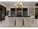 Bright dining area features modern chandelier, art pieces, and patio views through sliding glass doors at 2580 Saddleback Dr, Castle Rock, CO 80104