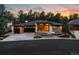 Stunning exterior view of a modern home with a three-car garage and beautiful landscaping at 2580 Saddleback Dr, Castle Rock, CO 80104