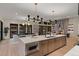 Open-concept kitchen featuring a large island, modern appliances, and seamless flow to the dining area at 2580 Saddleback Dr, Castle Rock, CO 80104