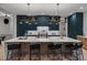 Stylish kitchen with a spacious island, designer lighting, and ample counter space at 2580 Saddleback Dr, Castle Rock, CO 80104
