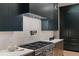 Close up of kitchen, stainless steel appliances, subway tile backsplash and cabinetry at 2580 Saddleback Dr, Castle Rock, CO 80104