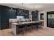 Modern kitchen with a large island, sleek cabinetry, and high-end appliances at 2580 Saddleback Dr, Castle Rock, CO 80104