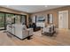 Inviting living room with comfortable seating, modern lighting, and access to an outdoor balcony at 2580 Saddleback Dr, Castle Rock, CO 80104