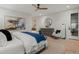 Bright main bedroom features a ceiling fan, light hardwood floors, and tasteful decor at 2580 Saddleback Dr, Castle Rock, CO 80104