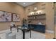 Stylish office features a glass desk, unique artwork, and shelving with decorative plants and modern lighting at 2580 Saddleback Dr, Castle Rock, CO 80104