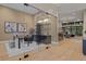 Bright office space with a glass door, modern desk, artwork, and access to the open floor plan at 2580 Saddleback Dr, Castle Rock, CO 80104