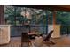 Covered deck with seating and a fireplace offering views of the surrounding trees and landscape at 2580 Saddleback Dr, Castle Rock, CO 80104