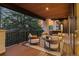 Covered deck with an outdoor seating area with wood decking and stone columns at 2580 Saddleback Dr, Castle Rock, CO 80104