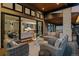 Covered deck with an outdoor seating area and a view of the spacious open floor plan interior at 2580 Saddleback Dr, Castle Rock, CO 80104