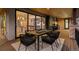 Outdoor patio with a dining table, chairs and view into the open-concept home with sliding glass doors at 2580 Saddleback Dr, Castle Rock, CO 80104