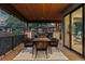 Covered patio featuring outdoor dining area with views of trees and adjacent building at 2580 Saddleback Dr, Castle Rock, CO 80104