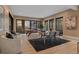 Large open-concept area combining game area and dining set, with walls of windows showcasing outdoors at 2580 Saddleback Dr, Castle Rock, CO 80104