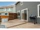 View of the back deck featuring wood-look floors, a divider, and a grill at 643 Ranchhand Dr, Berthoud, CO 80513