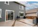 View of the back deck featuring wood-look floors, a grill, and gray siding at 643 Ranchhand Dr, Berthoud, CO 80513
