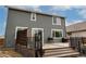 Exterior view of backyard featuring a deck, grill, and gray siding at 643 Ranchhand Dr, Berthoud, CO 80513