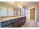 Bathroom vanity featuring dual sinks and large mirror at 643 Ranchhand Dr, Berthoud, CO 80513
