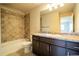 Bathroom featuring a shower/tub combination, single vanity, and a large mirror at 643 Ranchhand Dr, Berthoud, CO 80513