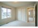 Bedroom featuring neutral carpeting, paint, a closet, and an open door to another room at 643 Ranchhand Dr, Berthoud, CO 80513