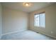 This bedroom has neutral carpeting and paint and a large window providing plenty of natural light at 643 Ranchhand Dr, Berthoud, CO 80513