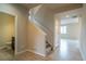 Inviting foyer with hardwood flooring, staircase, and access to a half bathroom at 643 Ranchhand Dr, Berthoud, CO 80513