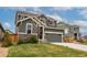 Charming two-story home with well-maintained lawn and a two car garage at 643 Ranchhand Dr, Berthoud, CO 80513