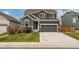 Charming two-story home with landscaped front yard and inviting, neutral color scheme at 643 Ranchhand Dr, Berthoud, CO 80513