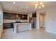 Modern kitchen with a granite island, stainless steel appliances and dark cabinetry at 643 Ranchhand Dr, Berthoud, CO 80513