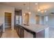 Kitchen island with granite countertop and stainless steel appliances with walk-in pantry at 643 Ranchhand Dr, Berthoud, CO 80513