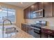 Modern kitchen featuring stainless steel appliances and granite countertops at 643 Ranchhand Dr, Berthoud, CO 80513