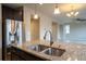 Gourmet kitchen featuring stainless steel appliances and a large island with a stainless sink at 643 Ranchhand Dr, Berthoud, CO 80513