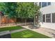 Backyard with artificial turf, tree, concrete patio and fencing at 2745 Java Ct, Denver, CO 80211