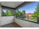 Balcony with wood flooring and a view of lush greenery and a neighboring house at 2745 Java Ct, Denver, CO 80211