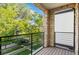 Inviting balcony with stone accents and a view of lush greenery offers a serene outdoor escape at 2745 Java Ct, Denver, CO 80211
